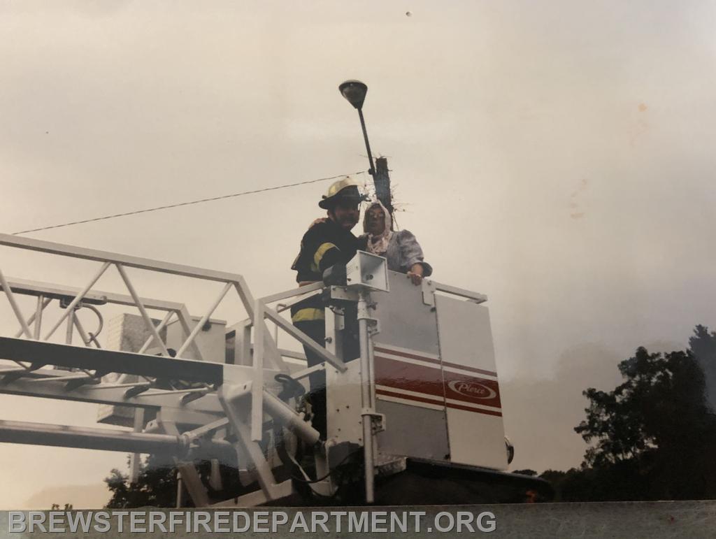 Photo #8
Victim is lowered in bucket by Lt. Phil McMurray Sr.  Definitely easier than walking down the ladder rungs. 